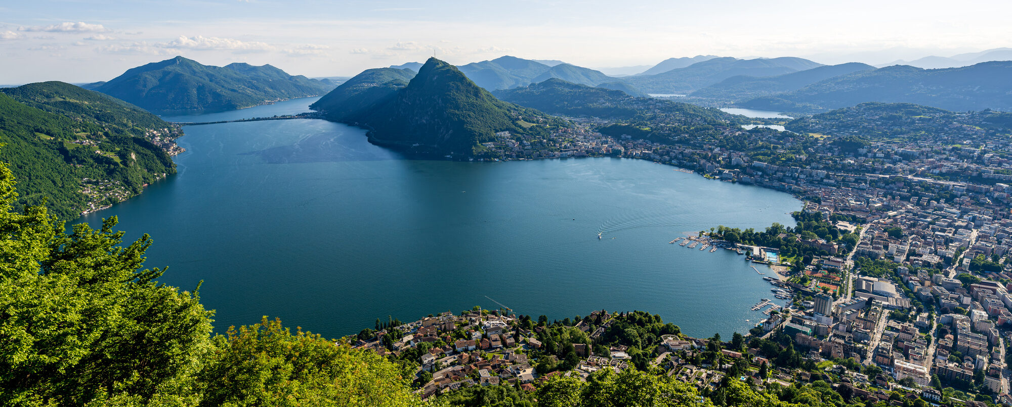 Lugano, Switzerland - Aerial view of the beautiful city of Lugano, showcasing Lake Lugano, surrounding mountains, and the stunning Swiss landscapes.